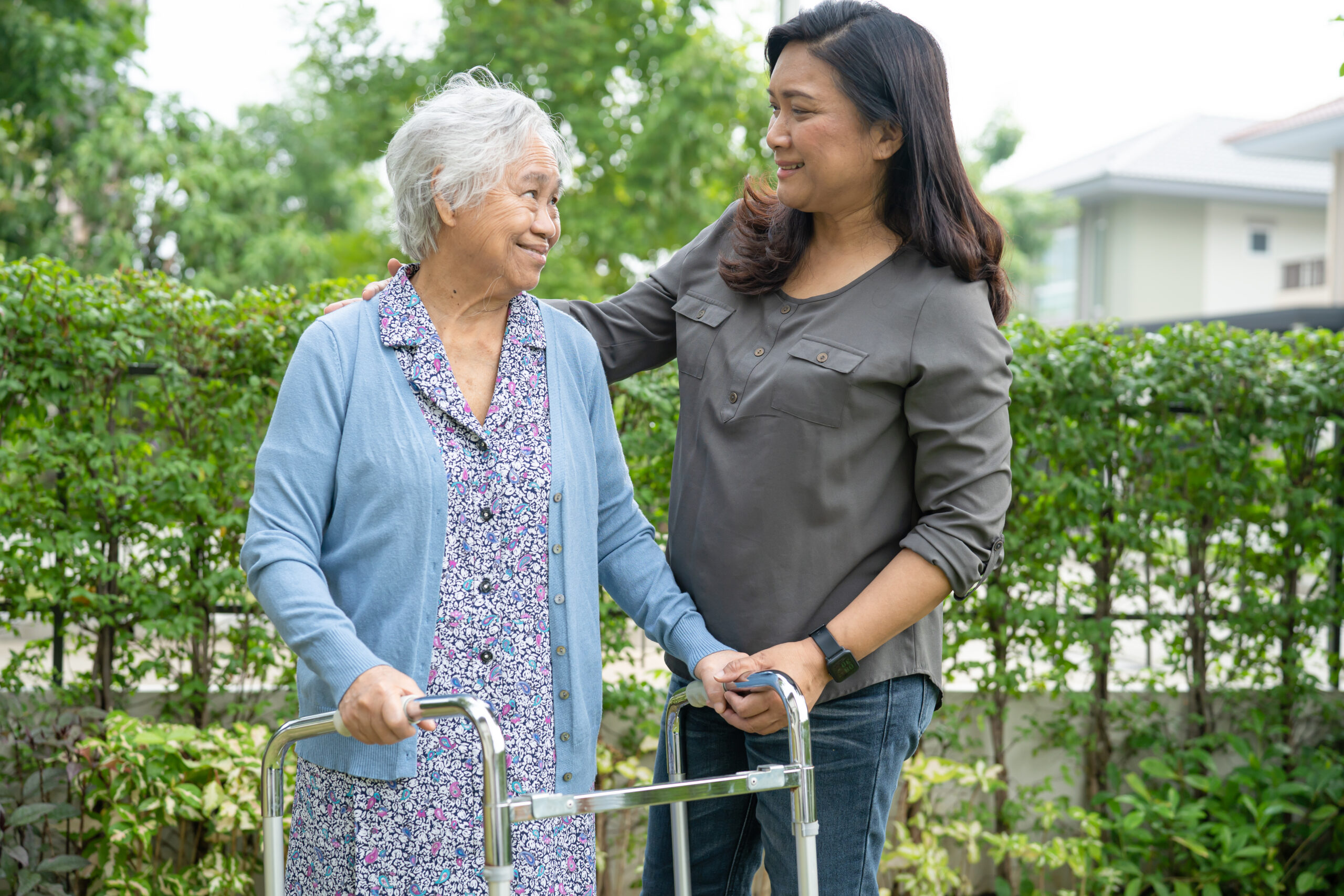 Help and care Asian senior or elderly old lady woman use walker